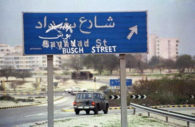 FILE - In this March 19, 1991 file photo, a Kuwait City street sign with the name Baghdad Street crossed out and the misspelled name of U.S. President George Bush painted in is a sign of the times in the recently liberated city. The oil-rich, tiny country of Kuwait is still shaped by the 1991 Gulf War. Twenty-five years later, there is a freely elected parliament in place but problems persist and many fear Kuwait could be gripped by the same regional tensions at play across the greater Middle East. (AP Photo/Greg Gibson, File)