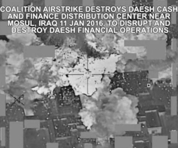 This image made from Jan. 11, 2016 video released by the U.S. military shows an airstrike targeting an Islamic State group cash and finance distribution center near Mosul, Iraq. The extremist group that once bragged about minting its own currency is having a hard time meeting expenses as a result of coalition airstrikes, plummeting oil prices and a cutoff of payments from the Iraqi government, the sum of which has eroded millions from its finances since last fall. The group that built up loyalty among its militants with good salaries and honeymoon and baby bonuses has stopped providing even the smaller perks: free energy drinks and Snickers bars. (Combined Joint Task Force-Operation Inherent Resolve via AP)