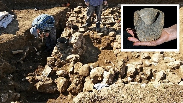 This handout photo released by the Israel Antiquities Authority on Wednesday, Feb. 15, 2016, shows work on uncovering of an ancient settlement in Jerusalem. Israeli archaeologists have discovered a 7,000-year-old settlement in northern Jerusalem in what they say is the oldest discovery of its kind in the area. ( Israel Antiquities Authority via AP)