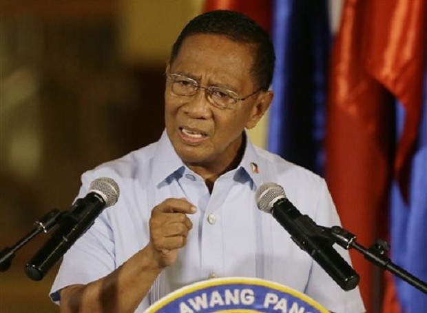 Philippine Vice-President Jejomar C. Binay gestures while reading his statement at a news conference, Wednesday, June 24, 2015 in Manila, Philippines. Binay, who submitted his irrevocable resignation as a member of President Benigno Aquino III's cabinet on Monday, announced Wednesday he would severe his ties with the present administration. (AP Photo/Bullit Marquez)