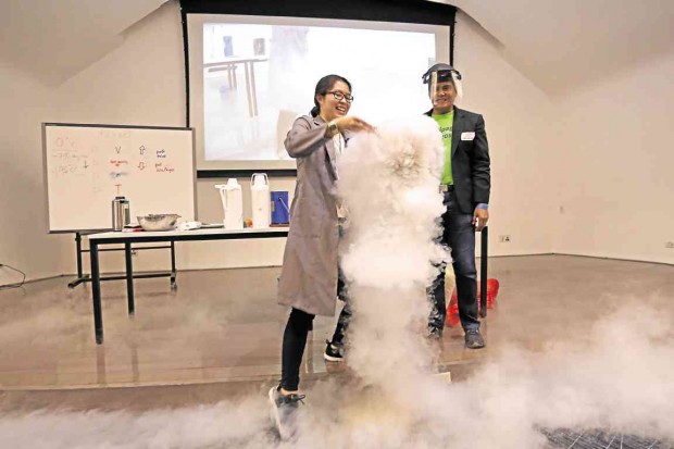  ‘HEROIC.’ Arcilla volunteers for an experiment that forms clouds on the floor and around the young museum visitors 