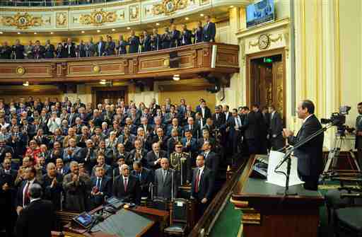 In this photo provided by Egypt's state news agency MENA, Egyptian President Abdel-Fattah el-Sissi, addresses parliament in Cairo, Egypt, Saturday, Feb. 13, 2016. El-Sissi, said his country has established a democratic system after years of turmoil following the 2011 uprising, but rights groups say his rule has been marked by an unprecedented crackdown on dissent. El-Sissi declared the completion of Egypt's transition to democratic rule in a 32-minute address to parliament, a 596-member chamber packed with his supporters