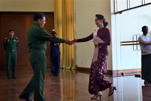 In this Wednesday, Dec. 2, 2015, photo, Senior General Min Aung Hlaing, left Commander in Chief of Myanmar Defense Services reaches to shake hands with pro-democracy icon Aung San Suu Kyi during their meeting in Naypyitaw, Myanmar. The new era dawns April 1, 2016, when Suu Kyis National League for Democracy, which captured nearly 80 percent of the contested parliamentary seats, takes over power from a military-dominated regime and attempts to shed decades of political oppression, civil war and economic ruin in this resource-blessed Southeast Asian nation once hailed as the continents rising star. (AP Photo/Aung Shine Oo)