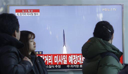 South Koreans watch a TV news program with a file footage about North Korea's rocket launch at Seoul Railway Station in Seoul, South Korea, Sunday, Feb. 7, 2016. North Korea on Sunday defied international warnings and launched a long-range rocket that the United Nations and others call a cover for a banned test of technology for a missile that could strike the U.S. mainland. The letters on the screen read: " North Korea launched a long-range missile." (AP Photo/Ahn Young-joon)