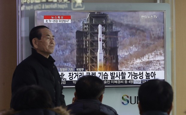 South Koreans watch a TV news program with a file footage about North Korea's rocket launch plans at Seoul Railway Station in Seoul, South Korea, Wednesday, Feb. 3, 2016. South Korea warned on Wednesday of "searing" consequences if North Korea doesn't abandon plans to launch a long-range rocket that critics call a banned test of ballistic missile technology. The headline on the screen read "North Korea plans to launch a long-rang rocket." (AP Photo/Ahn Young-joon)