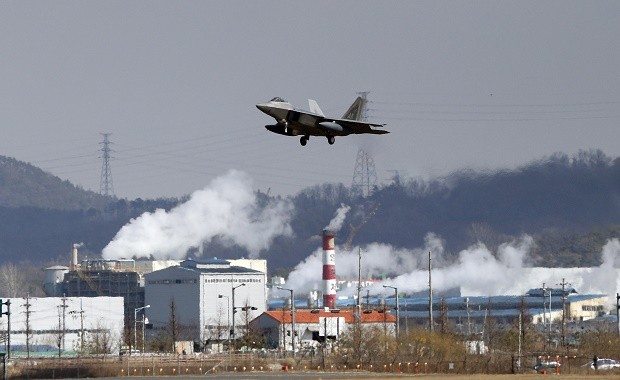 One of four U.S. F-22 stealth fighters flies over Osan Air Base in Pyeongtaek, South Korea, Wednesday, Feb. 17, 2016. Four U.S. F-22 stealth fighters flew over South Korea on Wednesday in a clear show of power against North Korea, a day after South Korea's president warned of the North's collapse amid a festering standoff over its nuclear and missile ambitions. (AP Photo/Lee Jin-man)