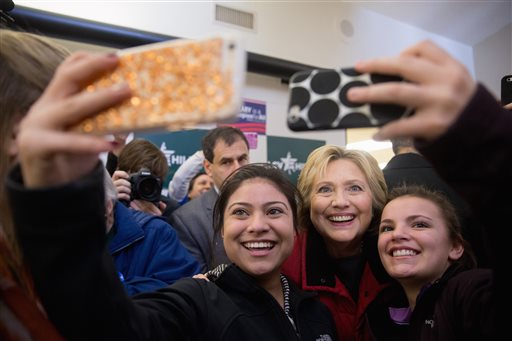 Democratic presidential candidate Hillary Clinton takes photos with workers at her campaign office in Des Moines, Iowa, Monday, Feb. 1, 2016. (AP Photo/Andrew Harnik)