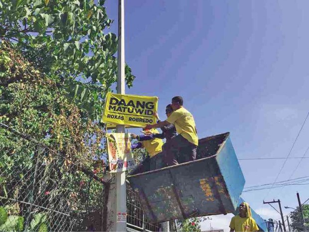 NO POSTER is too high to escape the reach of the MMDA’s “Oplan Baklas” clearing team which has been going around the metropolis to take down election materials displayed outside the Comelec’s designated common poster areas.  The discarded materials, which have been taken to its impounding area in Pasig City, may be distributed to schools for recycling or to NGOs which can turn these into bags, according to the MMDA.         Courtesy of MMDA Public Information Office