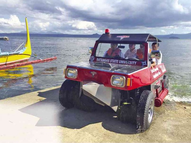 BATANGAS State University president Dr. Tirso Ronquillo together with the developers tests the amphibious vehicle on the Taal Lake.  MARRAH ERIKA RABE