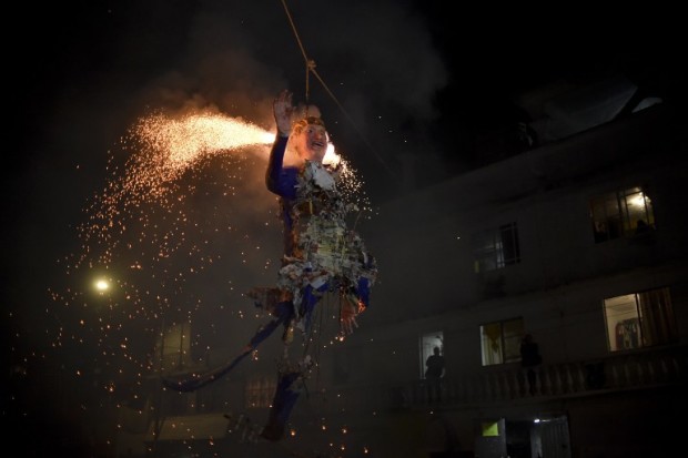 Mexican's set fire to an effigy of US Republican presidential candidate Donald Trump on  March 26, 2016 in Mexico City during Holy Week celebrations. For many years Mexicans have made cardboard figures representing all forms of evil, which are then torched commemorating the "Burning of Judas," a tradition in which Mexicans torch effigies of the devil, politicians and others they dislike on the eve of Easter Sunday.   Mexicans have found a new way to blow off steam over Donald Trump -- creating an effigy of the White House hopeful to burn in an Easter ritual. Some 61 percent of Mexicans hold a negative opinion of Trump -- who has vowed to force Mexico to pay for a huge wall across the US border to stop illegal migration -- an opinion poll found this month.  / AFP / YURI CORTEZ