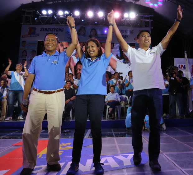 MARCH 28, 2016 United Nationalist Alliance (UNA) standard bearer Vice President Jejomar C. Binay raises the hands of his children, daughter Second District Makati Rep. Abegail "Abby" Binay (left), who is running for mayor of Makati, and Junjun Binat during the proclamation rally of Abby  held at  the intersection of Metropolitan Avenue, Chino Roces Avenue and Pablo Ocampo Extension. PHOTO BY JOAN BONDOC