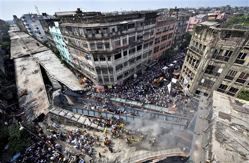 Locals and rescue workers clear the rubbles of a partially collapsed overpass in Kolkata, Thursday, March 31, 2016. Rescuers dug through large chunks of debris from the overpass that collapsed while under construction Thursday, killing many people and injuring scores of others, officials said. (Swapan Mahapatra/Press Trust of India via AP) INDIA OUT, CREDIT MANDATORY