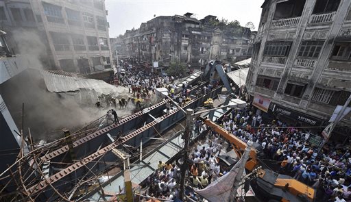 Locals and rescue workers clear the rubbles of a partially collapsed overpass in Kolkata, Thursday, March 31, 2016. Rescuers dug through large chunks of debris from the overpass that collapsed while under construction Thursday, killing many people and injuring scores of others, officials said. (Swapan Mahapatra/Press Trust of India via AP) INDIA OUT, MANDATORY CREDIT