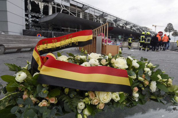 A wreath is placed in front of the damaged Zaventem Airport terminal in Brussels on Wednesday, March 23, 2016. Belgian authorities were searching Wednesday for a top suspect in the country's deadliest attacks in decades, as the European Union's capital awoke under guard and with limited public transport after scores were killed and injured in bombings on the Brussels airport and a subway station. AP
