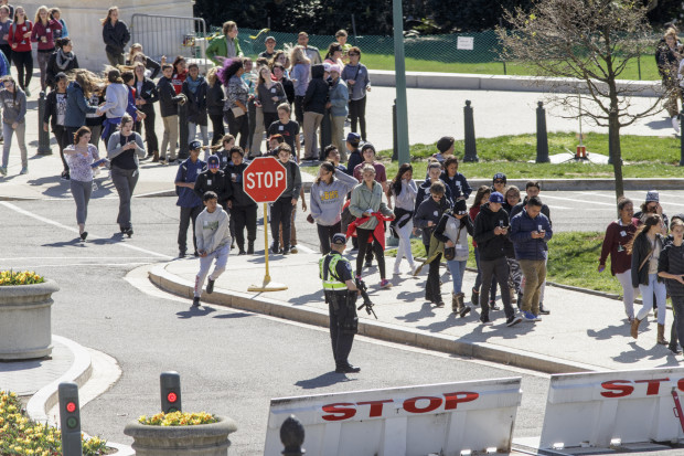 Tourists are directed by Capitol Police away from the Capitol on Constitution Ave. and Delaware Ave. in Washington, Monday, March 28, 2016. A gunman was taken into custody after firing shots in the U.S. Capitol complex, Capitol officials said, and visitors and staff were shut in their offices and told to “shelter in place.”   (AP Photo/J. Scott Applewhite)