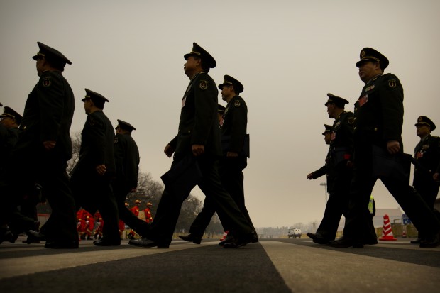 Delegates from the Chinese People's Liberation Army (PLA) arrive at the Great Hall of the People in Beijing, Friday, March 4, 2016. China said Friday it will boost military spending by about 7 to 8 percent this year, the smallest increase in six years, reflecting slowing economic growth and a drawdown of 300,000 troops as Beijing seeks to build a more streamlined, modern military. (AP Photo/Mark Schiefelbein)