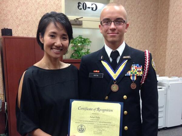 This May 2014 photo provided by Pennsylvania State Rep. Patty Kim shows Kim presenting a certificate to a man who identified as Harrisburg High School student Asher Potts. The school honors student just months from graduation was actually a 23-year-old Ukrainian national using a false identity after his visa expired, police said Thursday, Feb. 25, 2016. Artur Samarin, who used the alias Asher Potts, was arrested and charged Tuesday in Harrisburg, Pa., police said. (Pennsylvania State Rep. Patty Kim via AP)
