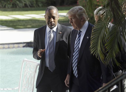 Former Republican presidential candidate Ben Carson talks with Republican presidential candidate Donald Trump before announcing he will endorse Trump during a news conference at the Mar-A-Lago Club, Friday, March 11, 2016, in Palm Beach, Fla. (AP Photo/Lynne Sladky)