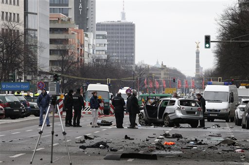 Police investigators stand on the site of the blast after a car exploded not far from the Victory Column in Berlin, eastern Germany, Tuesday, March 15, 2016. (AP Photo/Michael Sohn)