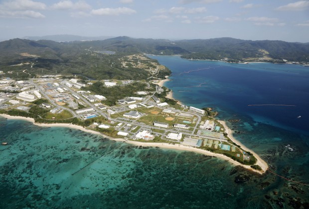 FILE - This aerial Oct. 29, 2015 file photo shows Henoko of Nago city, Okinawa prefecture, where the Japanese government plans to relocate a U.S. air base from one area of Okinawas main island to another. Japanese Prime Minister Shinzo Abe decided on Friday, March 4, 2016, to suspend work on moving a U.S. Marine base and talk about the contentious relocation on the southern island of Okinawa. Abe said he is accepting a court proposal not to force the land reclamation work over Okinawa's objections. Both sides have sued each other over the base relocation plan, and a court in February made the proposal as an interim step allowing the sides to talk. (Kazuhiko Yamashita/Kyodo News via AP, File) JAPAN OUT, MANDATORY CREDIT