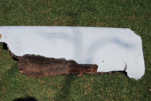 The curved piece of debris which may be part of the missing Malaysia Airlines Flight MH370, in Wartburg, 37km (22 miles) out of Pietermaritzburg, South Africa, Monday, March 7, 2016.  South African teenager Liam Lotter vacationing with his family in Mozambique on Dec. 30, may have found part of a wing from the missing plane, while he was strolling on the beach. Liam struggled to lift the debris from the beach and carried it back home to South Africa before discovering it might be from the lost plane, but now aviation experts plan to examine the plane fragment. The Malaysia Airlines Boeing 777 jet vanished with 239 people on board while flying from Kuala Lumpur to Beijing on March 8, 2014.  (Candace Lotter via AP)