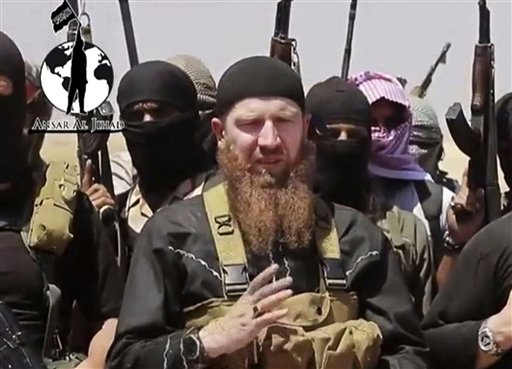 This image made from undated video posted during the weekend of June 28, 2014 on a social media account frequently used for communications by the Islamic State of Iraq and the Levant (ISIL), which has been verified and is consistent with other AP reporting, shows Omar al-Shishani standing next to the group's spokesman among a group of fighters as they declare the elimination of the border between Iraq and Syria. An Iraqi official and a Syrian activist say senior Islamic State group leader Al-Shishani died Monday, March 15, 2016 outside Raqqa, Syria. Shishani was injured in a U.S. airstrikes last week and subsequently died from his wounds, the senior Iraqi intelligence official and Rami Abdurrahman, of the Britain-based Syrian Observatory for Human Rights told the Associated Press. (AP Photo/militant social media account via AP video)