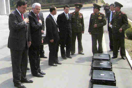  In this April 11, 2007, file photo, New Mexico Gov. Bill Richardson, left, and Anthony Principi, former U.S. veterans affairs secretary, second from left, pay respects to the remains of six American soldiers from the Korean War inside of black cases on North Korea's side of the border village of Panmunjom. "Until They Are Home" is one of the most sacred vows of the U.S. military, yet there are 5,300 American GIs missing in North Korea from the Korean War whose remains are potentially recoverable. It has been more than a decade since any U.S. search teams have tried, and with construction projects across the country moving forward, many could already be lost forever. (AP Photo/Foster Klug, File)