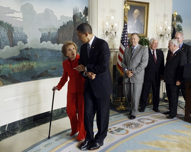 FILE - In this June 2, 2009, file photo, President Barack Obama escorts former first lady Nancy Reagan after signing the Ronald Reagan Centennial Commission Act, during a ceremony in the Diplomatic Reception Room of the White House in Washington. The former first lady has died at 94, The Associated Press confirmed Sunday, March 6, 2016. (AP Photo/Haraz N. Ghanbari, File)