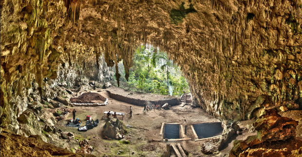 This 2012 photo provided by the Smithsonian Institution and the Liang Bua Team shows Liang Bua, a limestone cave on the Indonesian island of Flores, as the Liang Bua Team prepares for new archaeological excavations. In 2004, researchers reported that evolutionary cousins of modern humans, nicknamed hobbits, lived until fairly recently in the cave. Now a new study indicates they died out much earlier than originally believed. (Smithsonian Digitization Program Office and Liang Bua Team via AP) MANDATORY CREDIT