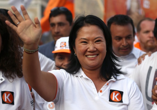 Presidential candidate Keiko Fujimori, of the "Fuerza Popular" political party, waves to supporters as she campaigns in San Juan de Lurigancho shantytown on the outskirts of Lima, Peru, Tuesday, March 22, 2016. Keiko, the daughter of former President Alberto Fujimori, is running for president in Peru's April 10 election. (AP Photo/Martin Mejia)