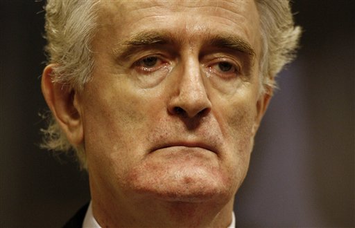 FILE - In this Thursday July 31, 2008 file photo, former Bosnian Serb leader Radovan Karadzic stands in the courtroom during his initial appearance at the U.N.'s Yugoslav war crimes tribunal in The Hague, Netherlands. More than 20 years after Bosnia's war, Radovan Karadzic will learn his fate on Thursday when U.N. judges deliver verdicts in his genocide and war crimes trial. (Jerry Lampen/Pool via AP, File)