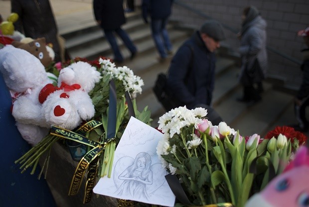 A child's illustration shows an angel among flowers outside a subway station in Moscow, Russia, on Tuesday, March 1, 2016. Russian police on Monday arrested a woman who was seen waving the severed head of a small child outside a Moscow subway station. She is suspected of killing the child when it was in her care. (AP Photo/Ivan Sekretarev)