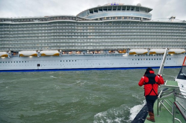 A Loire river pilot looks at the Harmony of the Seas cruise ship as it leaves the STX shipyard of Saint-Nazaire, western France, for a three-day offshore test, on March 10, 2016 (AFP Photo/Loic Venance) 