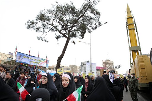Iranians attend a rally commemorating the 37th anniversary of the Islamic revolution, under Emad long-range ballistic surface-to-surface missile, displayed by armed forces, in Tehran, Iran, Thursday, Feb. 11, 2016. The nationwide rallies commemorate Feb. 11, 1979, when followers of Ayatollah Khomeini ousted U.S.-backed Shah Mohammad Reza Pahlavi. (AP Photo/Ebrahim Noroozi)