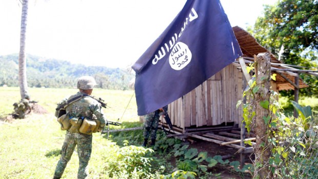 CAPTURED REBEL CAMP Philippine Marines secure an area of a camp they captured held by Islamic extremists in Sultan Kudarat province. JEOFFREY MAITEM/ INQUIRER MINDANAO