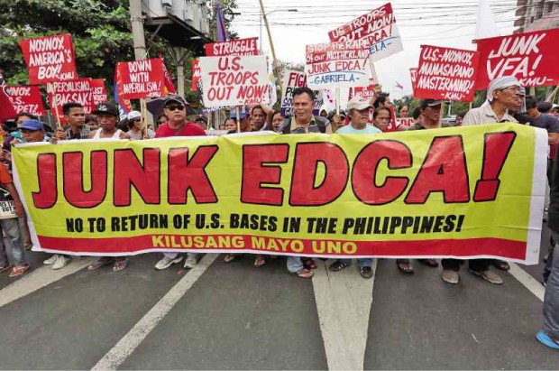 PROTESTERS try to get near the US Embassy in Manila to denounce what they described as a lopsided Enhanced Defense Cooperation Agreement (Edca), a pact signed by Philippine and US government officials.          GRIG C. MONTEGRANDE