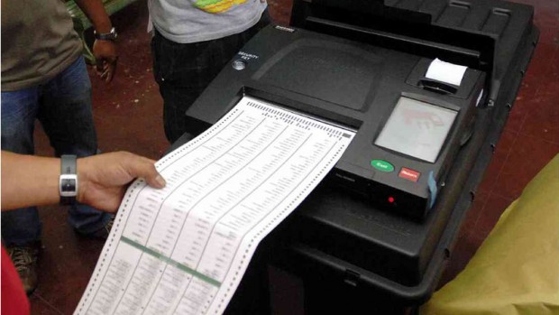 A ballot is fed into the vote counting machine during a local election in this file photo.