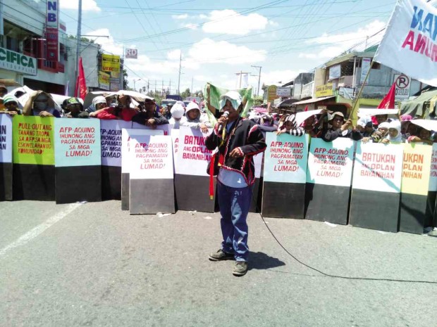 PROTESTERS, led by leaders and members of the lumad group Pasaka, block a four-lane highway connecting Davao City with six provinces to demand a stop to lumad killings and the withdrawal of government soldiers in lumad communities.            BARRY OHAYLAN/CONTRIBUTOR
