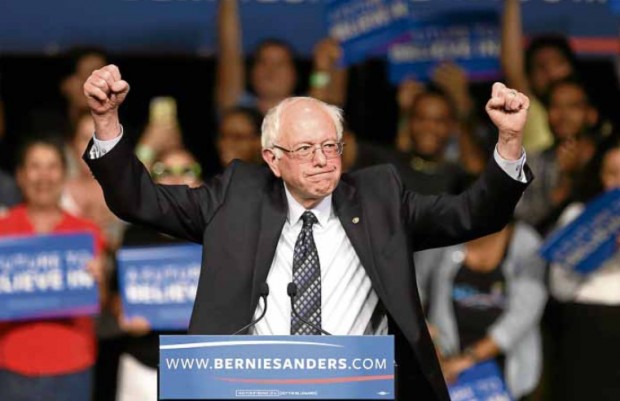 FOR THE WIN Sen. Bernie Sanders rallies supporters upon his arrival at a campaign rally in Miami on Tuesday. The Vermont official scored a surprise win in Michigan over rival Hillary Clinton in the Democratic presidential primaries. AP