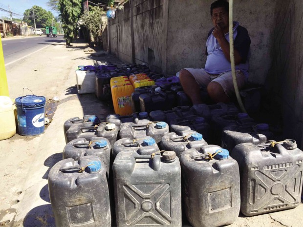CONTAINERS are waiting to be filled with water in a village faucet in Zamboanga City, which is suffering from drought as a result of the El Niño phenomenon.          JULIE ALIPALA/INQUIRER MINDANAO