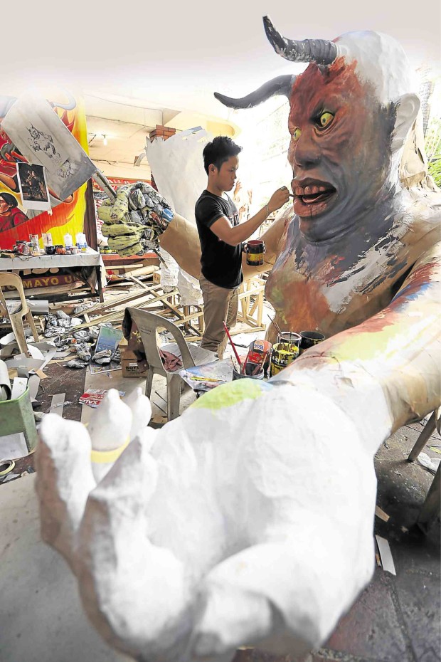  ALL IN THE DETAILS. An artist takes Labor Day issues by the horns as he prepares an effigy of President Aquino for the May 1 rally of the Kilusang Mayo Uno. NIÑO JESUS ORBETA 