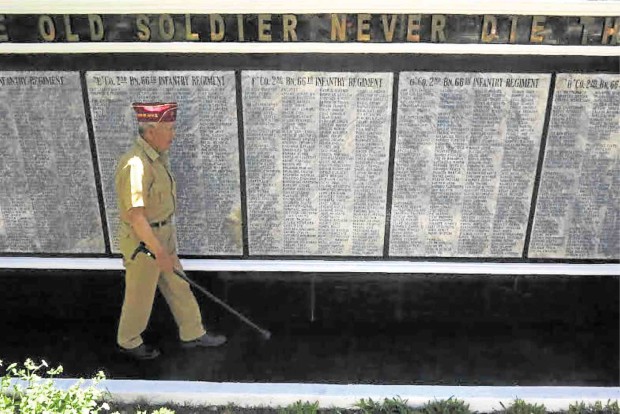 VALOR WALL  Marciano Miles, 92, walks by a wall featuring the names of soldiers and guerrillas who liberated Baguio City on April 27, 1945. Miles is a surviving member of the 66th Infantry Regiment, the so-called Igorot infantry that fought the Japanese during World War II. EV ESPIRITU/INQUIRER NORTHERN LUZON