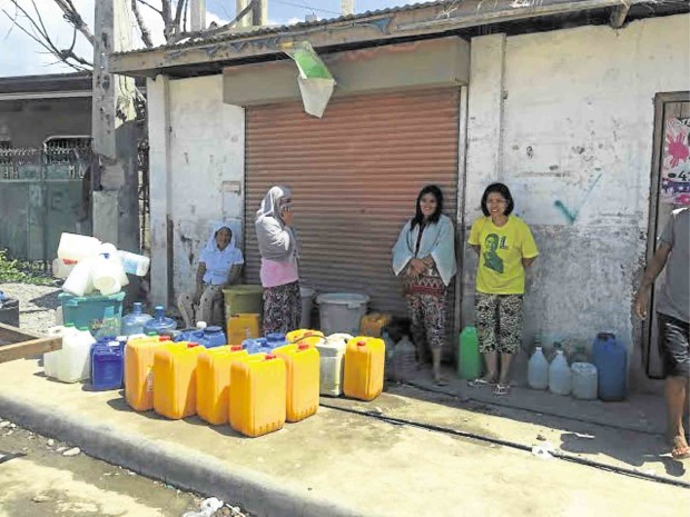 RESIDENTS of Barangay Rio Hondo in Zamboanga City await their rationed supply of water as the intense heat dries up water sources in the city. JULIE S. ALIPALA / Inquirer Mindanao
