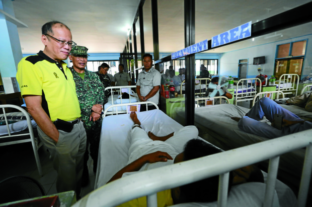 PRESIDENT AQUINO VISITS WOUNDED SOLDIERS IN ZAMBOANGA/ APRIL 14,2016 President Benigno Aquino lll visits wounded soldiers victims of the 10-hour encounter with Abu Sayyaf bandits in tipo-tipo on Basilan on Saturday in which 18 soldiers died and 52 other soldiers were wounded.  The soldiers are now confined at Camp Navarro General Hospital in Zamboanga city. besides the President is Col Felix Tayo, Commanding officer of the Hospital. INQUIRER PHOTO/JOAN BONDOC