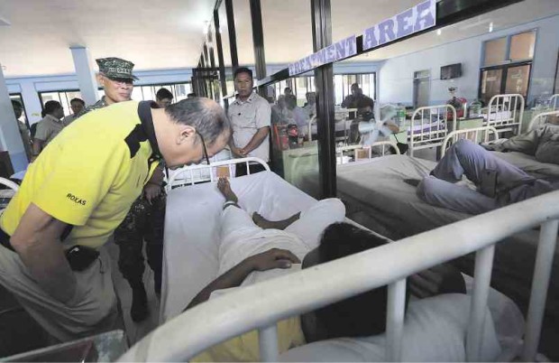  WITH THE WOUNDED Four days after Abu Sayyaf bandits ambushed soldiers in Tipo-Tipo, Basilan, President Aquino visits the wounded at Camp Navarro General Hospital in Zamboanga City. Eighteen soldiers died and 52 others were wounded in the 10-hour gun battle. JOAN BONDOC 