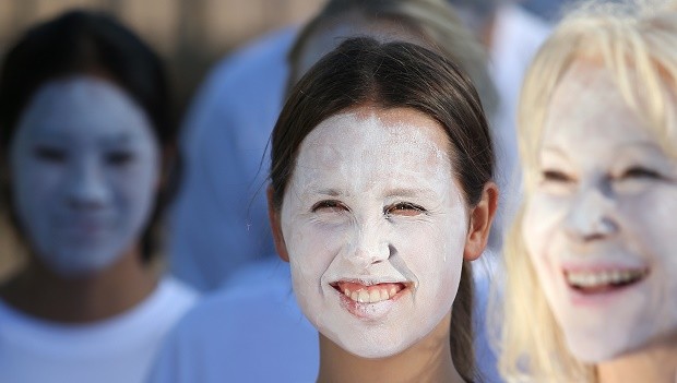 Demonstrators from the environmental group Greenpeace paint their faces white to protest coral bleaching in Sydney, Friday, April 22, 2016. The group are attempting to raise concerns of climate change when as many as 170 countries are expected to sign the Paris Agreement on climate change as the landmark deal takes a key step toward entering into force years ahead of schedule. AP 