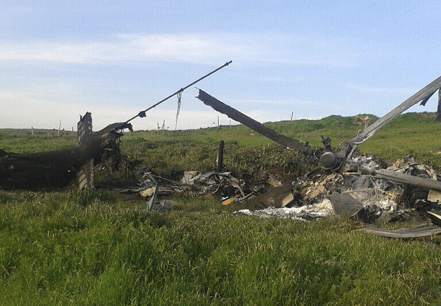 Remains of a downed Azerbaijani forces helicopter lies in a field in the separatist Nagorno-Karabakh region, on Saturday, April 2, 2016.  In a statement, Azerbaijan's Defense Ministry said 12 of its soldiers "became shards" (Muslim martyrs) and said one of its helicopters was shot down.  At least 30 soldiers and a boy were reported killed as heavy fighting erupted Saturday between Armenian and Azerbaijani forces over the separatist region of Nagorno-Karabakh. (AP Photo)