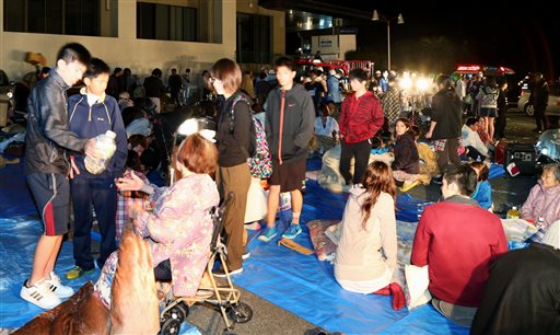 Stranded people gather outside a town hall of Mashiki, after an earthquake in Kumamoto, southern Japan, Thursday, April 14, 2016.  A powerful earthquake with a preliminary magnitude of 6.4 has struck southern Japan, collapsing walls and a number of houses.  (Kyodo News via AP) JAPAN OUT, MANDATORY CREDIT