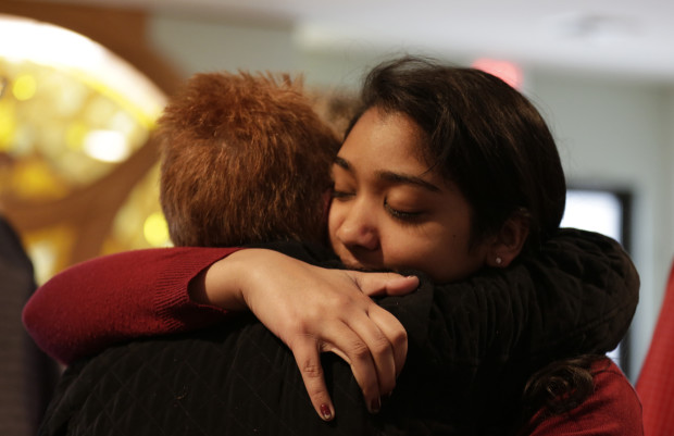 Nikita Deep, 16, embraces a family friend at Antigo United Methodist Church following a morning service Sunday, April 24, 2016, in Antigo, Wis. According to police Jakob E. Wagner, 18, opened fire with a high-powered rifle outside of the a prom at Antigo High School late Saturday. Deep is class president at the school and was involved in the coordination of the prom.  (Jacob Byk/The Marshfield News-Herald via AP) NO SALES; MANDATORY CREDIT