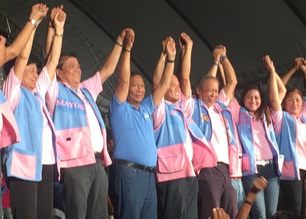Vice President Jejomar Binay raises the hands of reelectionist Binmaley mayor Simplicio "Sammy" Rosario (left of Binay), who was a contractor for Makati when Binay was then mayor. Photo by Marc Jayson Cayabyab